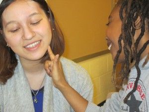 Jianna applies stage make-up to Jasmine, our volunteer.