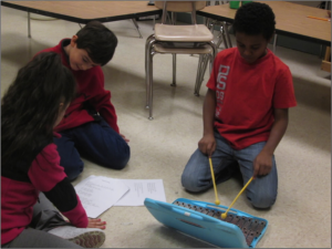 Composers Katie, Dominic and Daylon offer ideas for the theme song.